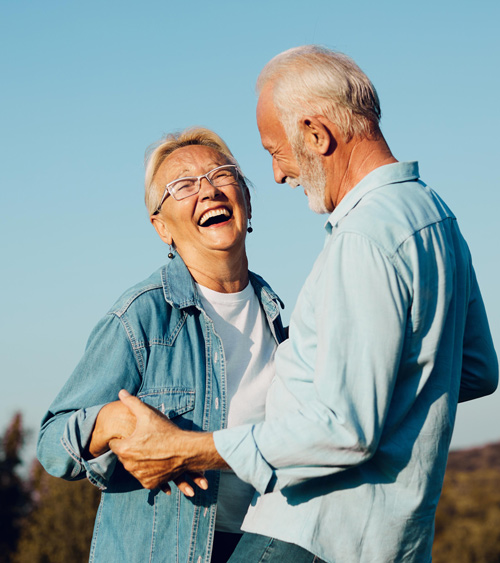 happy elderly couple dancing together outdoors in casual attire celebrating love and joy in their golden years with 11 moments of laughter